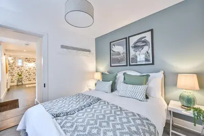 a bedroom with a large bed with pillows at Old Cobblers in Port Isaac
