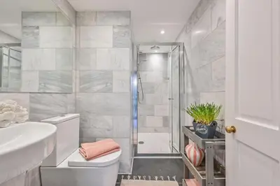a bathroom with a shower and a toilet and a sink at Old Cobblers in Port Isaac