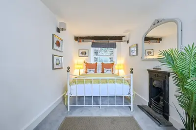 a bedroom with a bed and a fireplace at Old Cobblers in Port Isaac