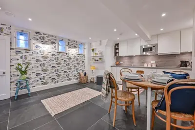 a kitchen and dining room with a table and chairs at Old Cobblers in Port Isaac