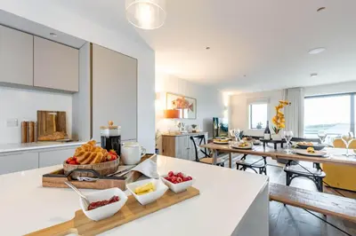 a kitchen with a tray of food on a counter at Porth Beach Villa in Newquay