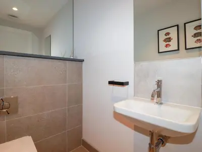 a bathroom with a sink and a mirror at Porth Beach Villa in Newquay