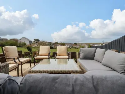 a living room with a couch and two chairs at Lavender House in Newquay
