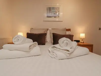 a bedroom with white towels on a bed at Moonsail in Carbis Bay