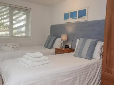 a bedroom with two beds with towels on them at Moonsail in Carbis Bay