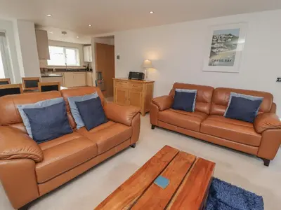 a living room with two leather couches and a coffee table at Moonsail in Carbis Bay