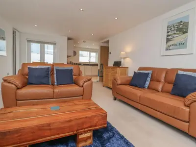 a living room with two brown couches and a coffee table at Moonsail in Carbis Bay