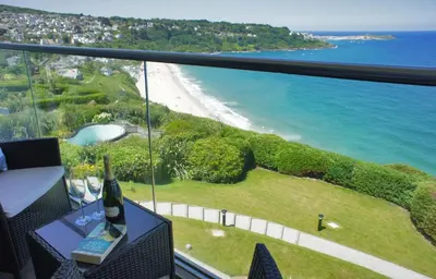 a room with a view of a beach and the ocean at Glas Mor in Carbis Bay