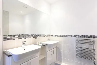 a bathroom with two sinks and a mirror at Glas Mor in Carbis Bay