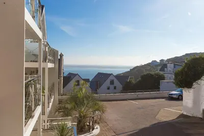 a parking lot with a view of the ocean at The Waves in St Ives