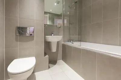 a bathroom with a toilet and a sink and a tub at The Waves in St Ives