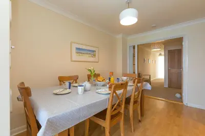 a dining room with a table and chairs at Dolphin Watch in Carbis Bay