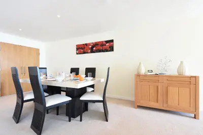 a dining room with a black table and chairs at Ocean View in Carbis Bay