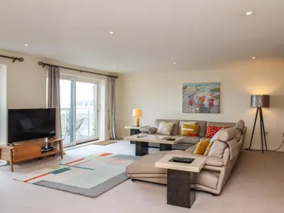 a living room with a couch and a tv at Ocean View in Carbis Bay