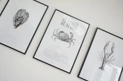 a group of framed drawings of crabs on a wall at Gwel An Chapel in Carbis Bay