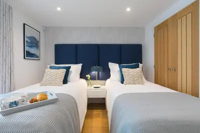 a hotel room with two beds and a tray of food at Gwel An Chapel in Carbis Bay