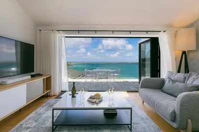 a living room with a view of the ocean at Gwel An Chapel in Carbis Bay