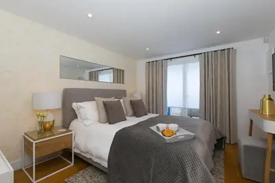 a hotel room with a bed with a tray on it at Gwel An Chapel in Carbis Bay