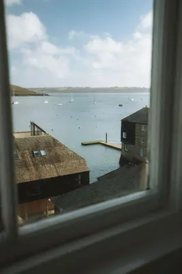 a view of a body of water from a window at Breathtaking High Street Townhouse With Stunning Sea Views at 'The Old Fishermans Townhouse' in Falmouth