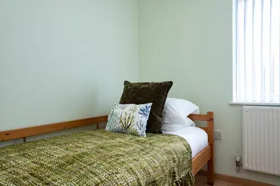 a bedroom with a bed with a pillow on it at Blue Ridge in Wadebridge