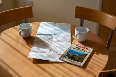 a table with a map and a book and two cups at Blue Ridge in Wadebridge