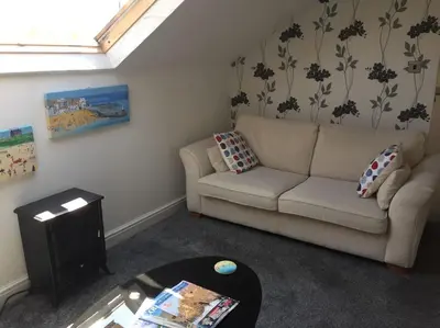 a living room with a couch and a table at Poppy's Place Annex in Camelford North Cornwall in Camelford