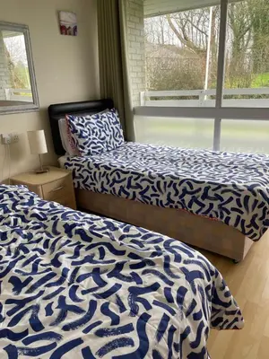 a bedroom with two beds and a window at Atlantic Lodge in Newquay