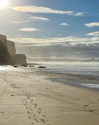 a footprints in the sand on a beach at Atlantic Lodge in Newquay