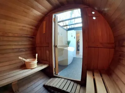a small room with a door in a sauna at Romance - Stargazing - Hot tub & sauna! in Camborne