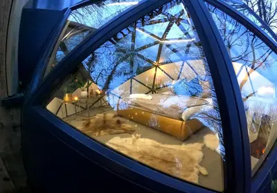 a reflection of a bed in a window at Romance - Stargazing - Hot tub & sauna! in Camborne