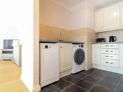 a laundry room with a washer and dryer at Gweal in Truro