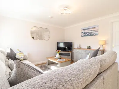 a living room with a couch and a tv at Gweal in Truro