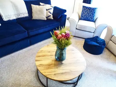a vase of flowers sitting on a table in a living room at Tolcarne - Perranporth Cornwall in Perranporth