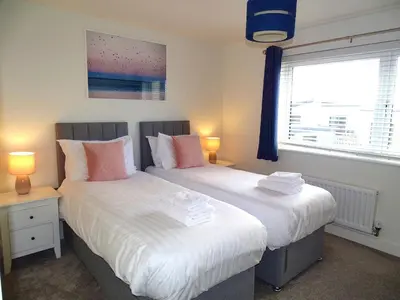 two beds sitting next to each other in a bedroom at Tolcarne - Perranporth Cornwall in Perranporth