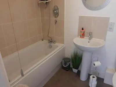 a bathroom with a sink and a tub and a toilet and a sink at Cozy Courtyard Apt Explore & Relax Free Parking in Bodmin