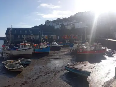 a group of boats sitting on the beach at Cozy Courtyard Apt Explore & Relax Free Parking in Bodmin