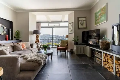 a living room with a couch and a tv at Marners Rock No 3 in Fowey