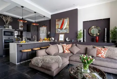 a living room with a couch and a kitchen at Marners Rock No 3 in Fowey