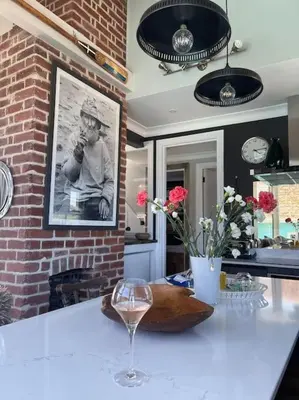 a kitchen with a table with a glass of wine at Marners Rock No 2 in Fowey