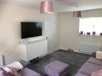 a living room with a flat screen tv on a wall at 4 bedroom luxurious detached home in Liskeard