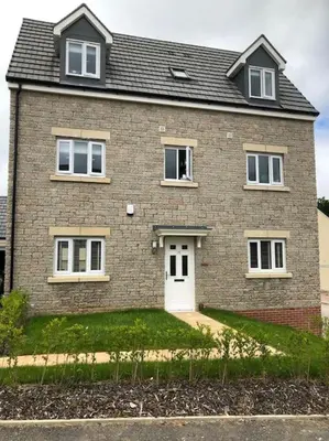 a large brick house with a white door at 4 bedroom luxurious detached home in Liskeard