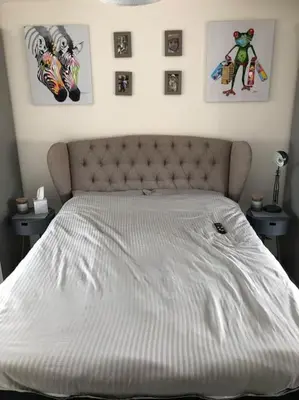 a white bed in a bedroom with pictures on the wall at 4 bedroom luxurious detached home in Liskeard