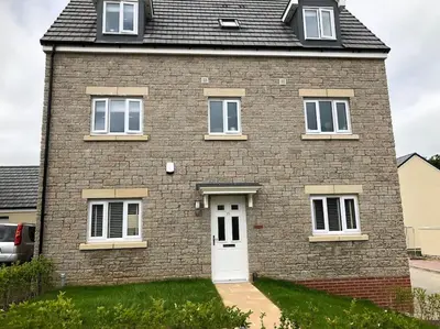 a brick house with a white door at 4 bedroom luxurious detached home in Liskeard