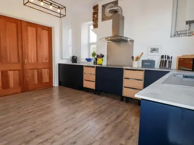 a large kitchen with a counter and a sink at Melvill House in Falmouth