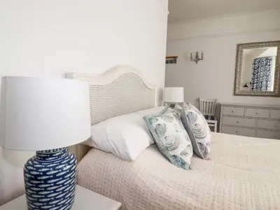 a bedroom with a bed with a lamp and pillows at Melvill House in Falmouth