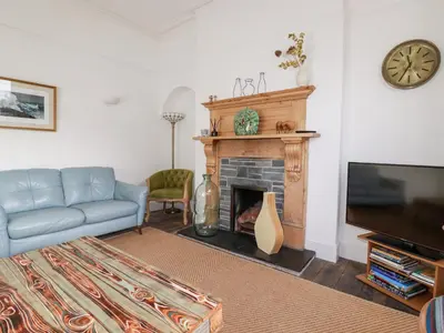 a living room with a couch and a fireplace at Melvill House in Falmouth