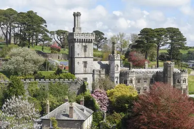 an old castle on a hill with trees at Marners Rock No 1 in Fowey