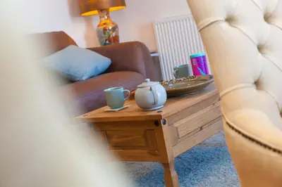 a living room with a couch and a coffee table at Sand Dunes 6 The Manor in St Ives