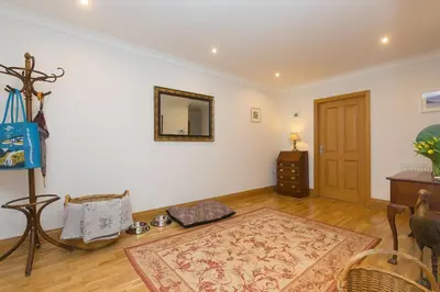 a living room with a door and a rug at Sand Dunes 6 The Manor in St Ives