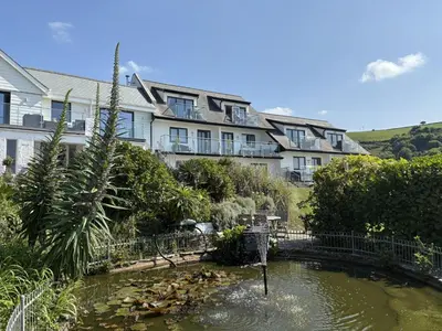 a pool of water in front of a building at Oystercatcher - Mount Brioni in Downderry